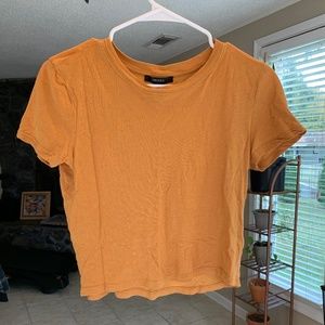 A women’s medium cropped Forever 21 yellow t-shirt.